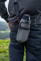 water to go insulated bottle carrier worn by a man in black clothing on a hill