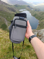 Water to go Insulated Bottle Carrier in grey on a mountain overlooking a lake